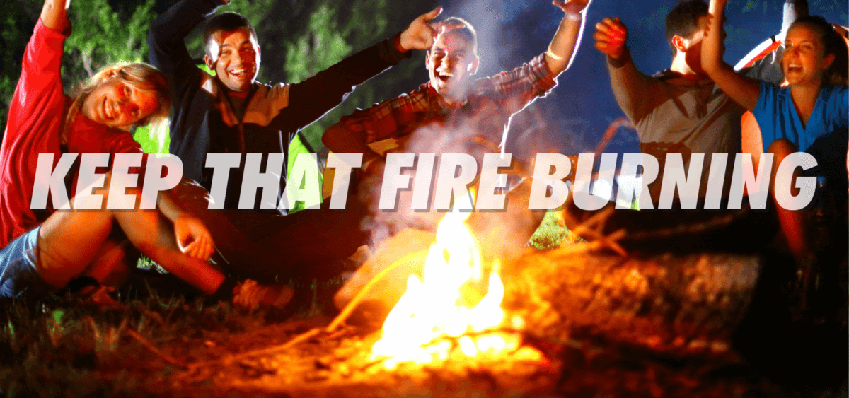 People Writing jokes around a campfire 