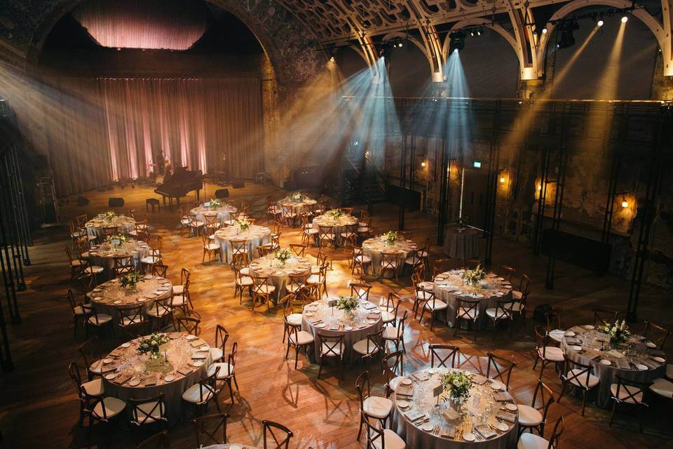 Large ballroom, tables, wedding reception.