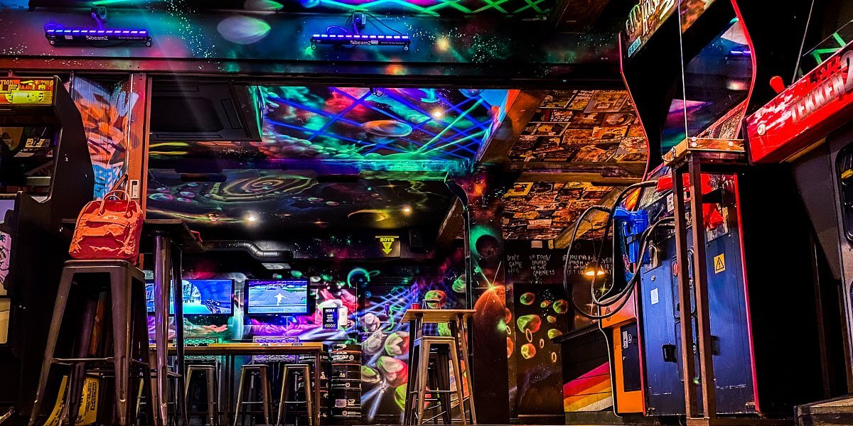Neon bar, arcade games.