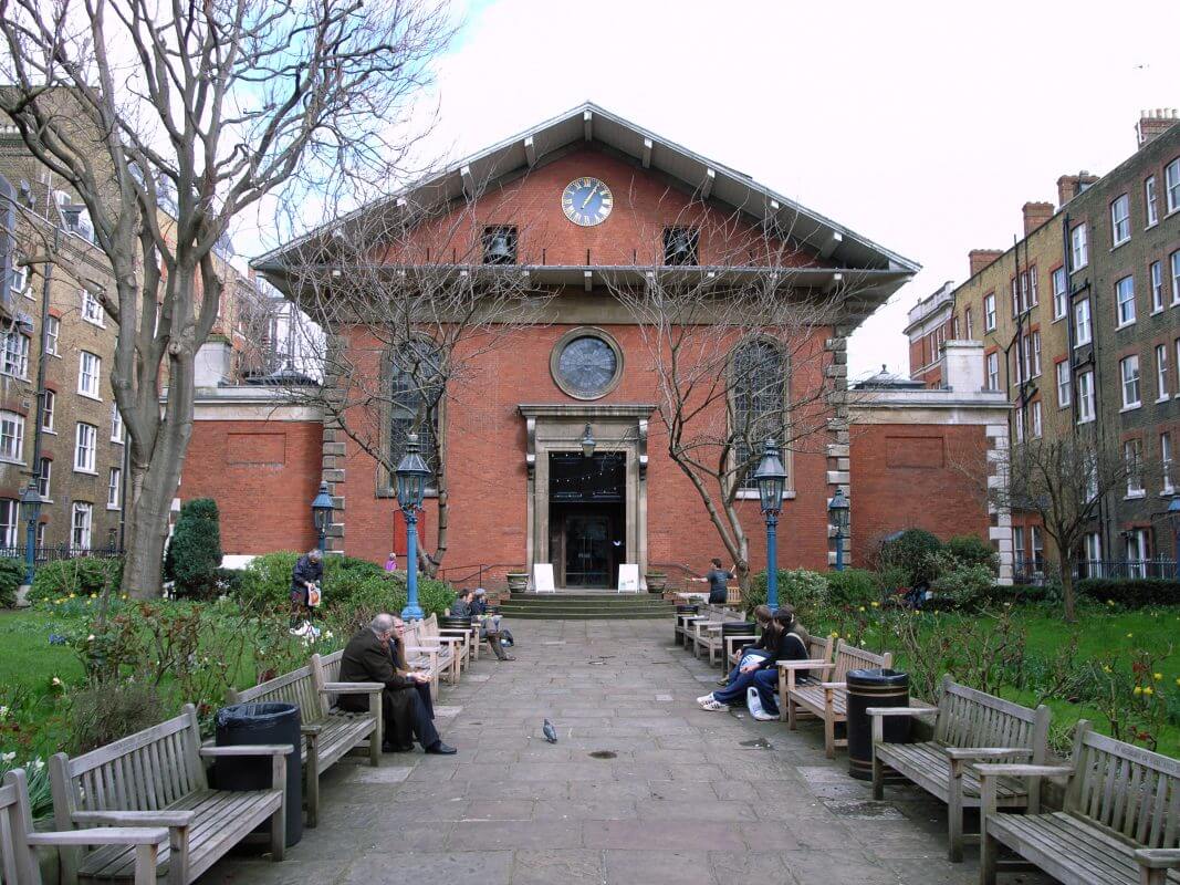 A brick building with benches.