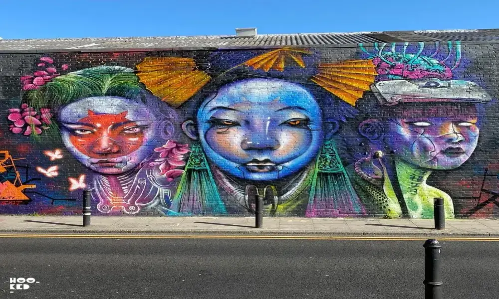 A colorful mural on a wall with a woman's face on it.
