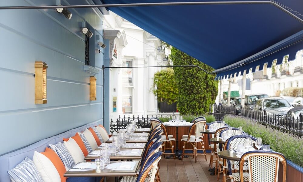 An outdoor dining area with a blue awning.