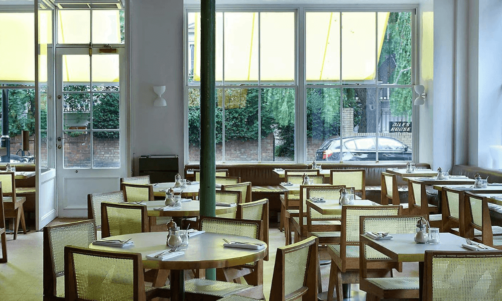 The interior of a restaurant with tables and chairs.
