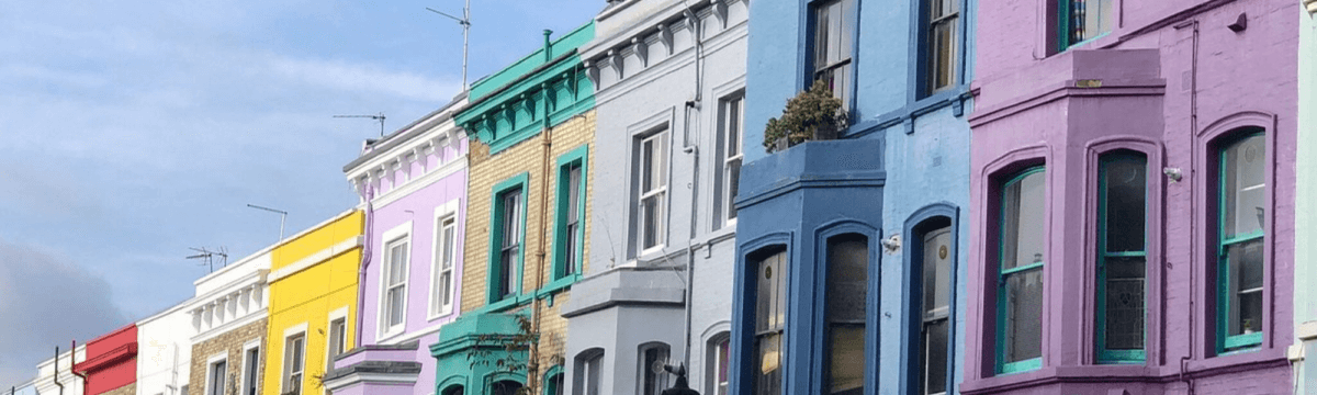 A row of colorful houses on a street in london.