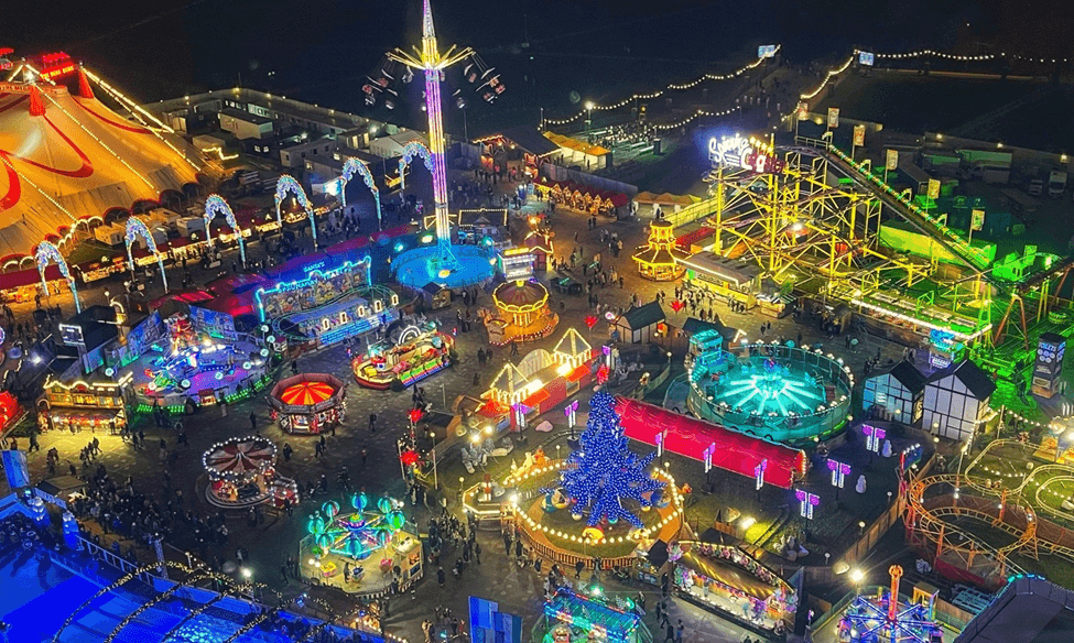 An aerial view of an amusement park at night.