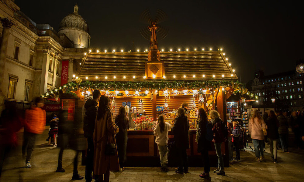 A christmas market in london at night.
