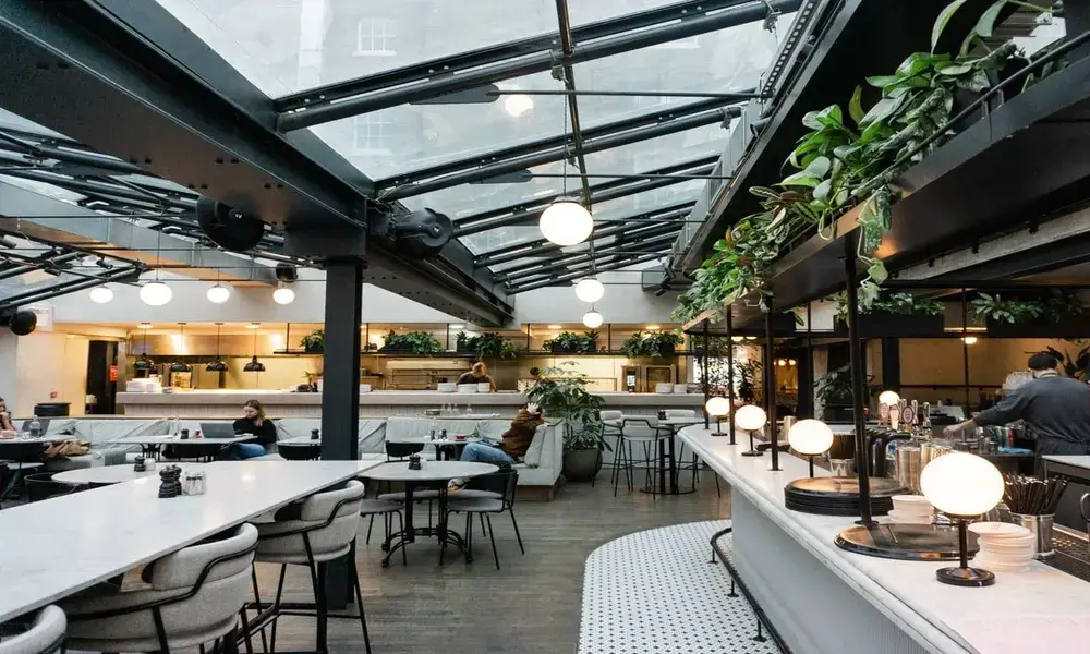 The interior of a restaurant with a glass roof.