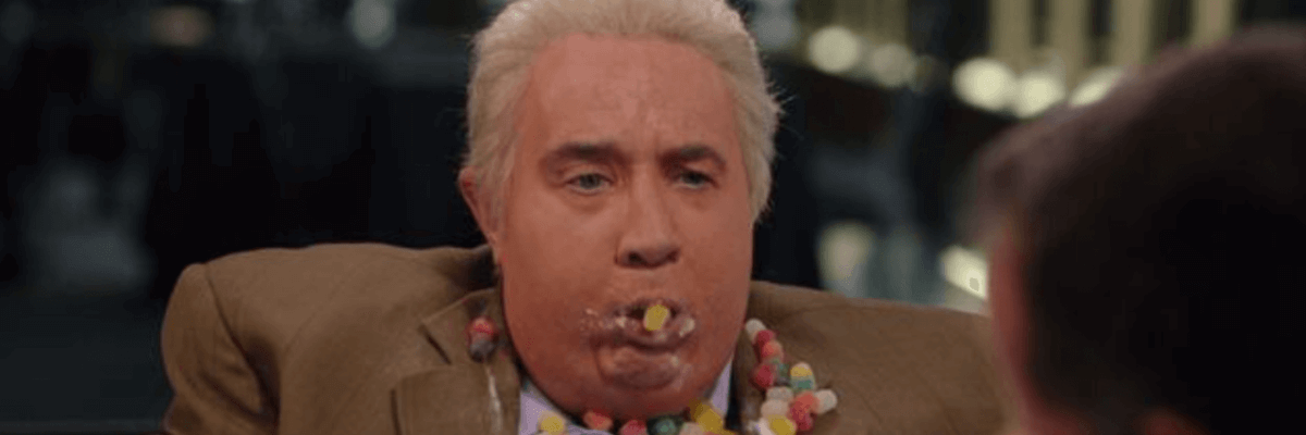 A man in a suit with candy in his mouth.