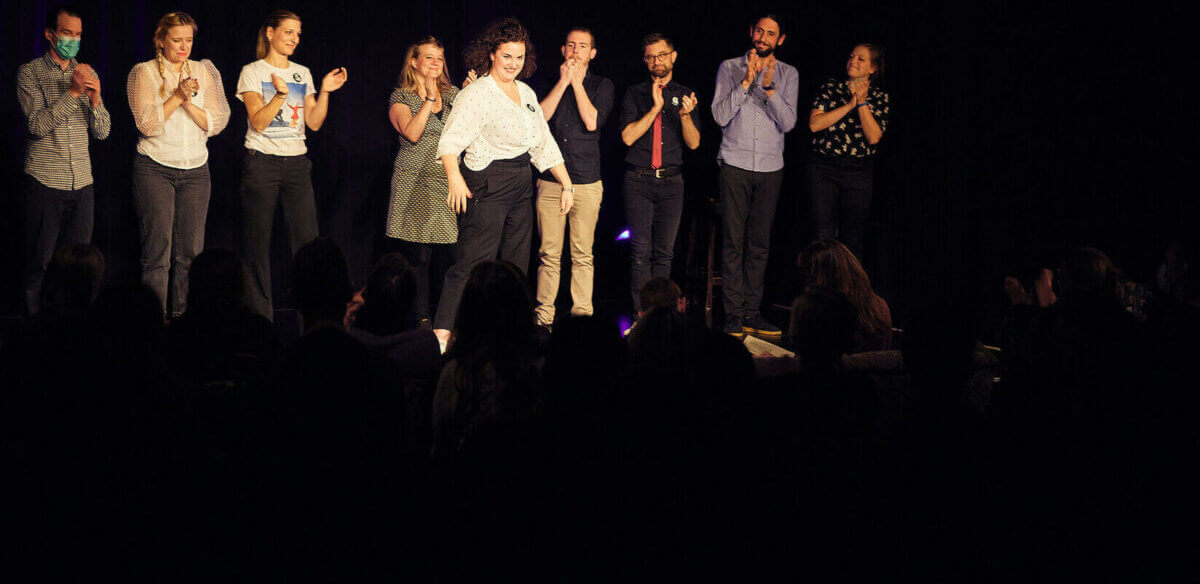A group of people standing on a stage.