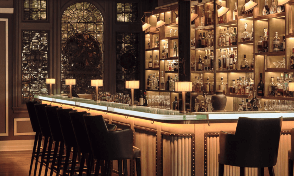 A bar with a lot of bottles on it.