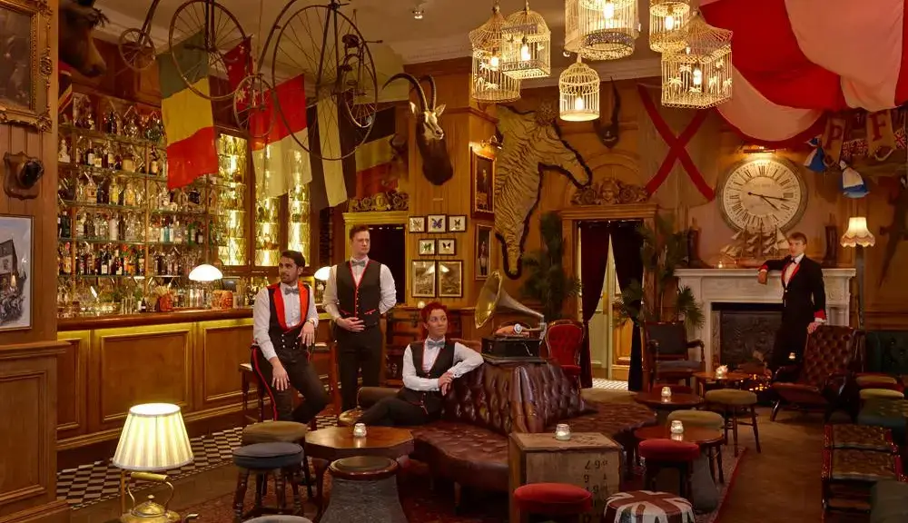 A group of people are sitting in a room with a lot of decorations.