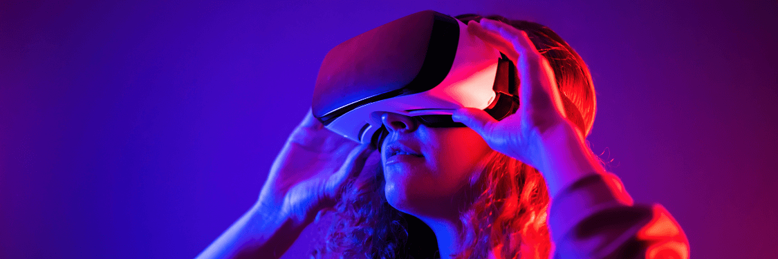 A woman wearing a vr headset in front of a colorful background.