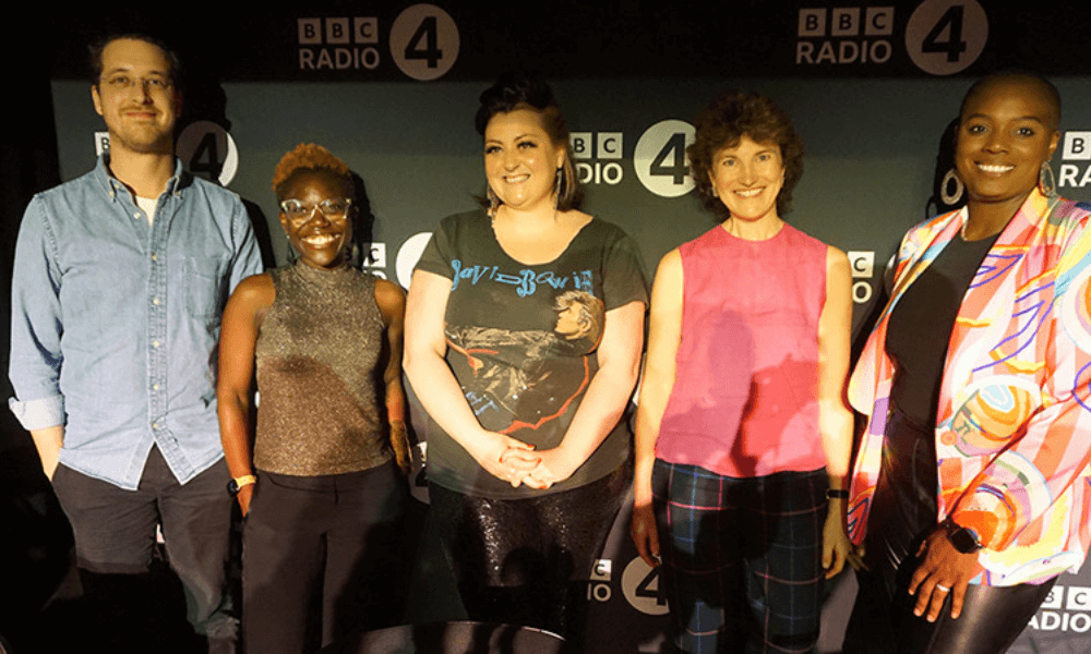A group of people standing in front of a bbc radio 4 sign.