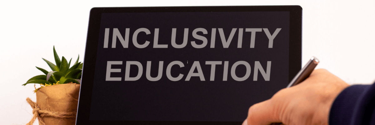 A person holding a tablet with the word inclusion education on it.