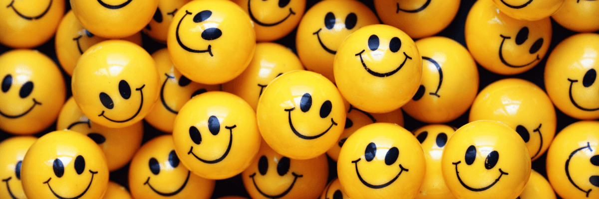 A group of yellow smiley faces arranged in a row.