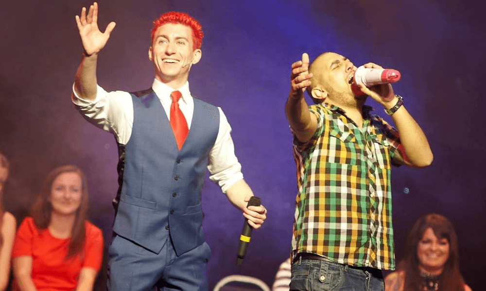 Two men with red hair singing on stage.